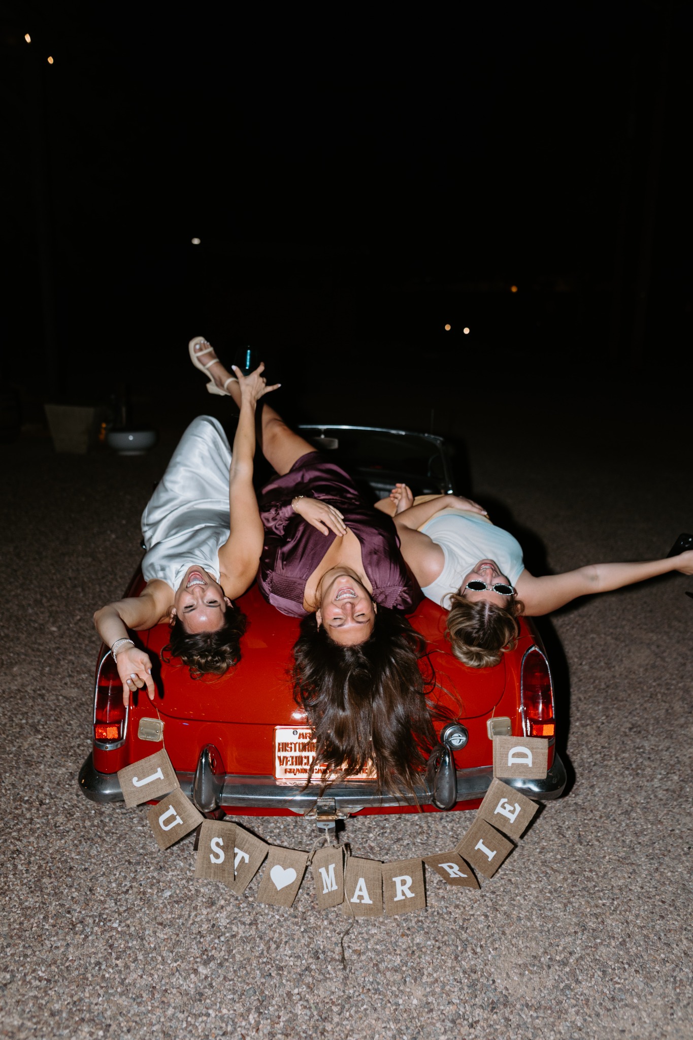 Wedding party celebrating on the back of the maroon MG